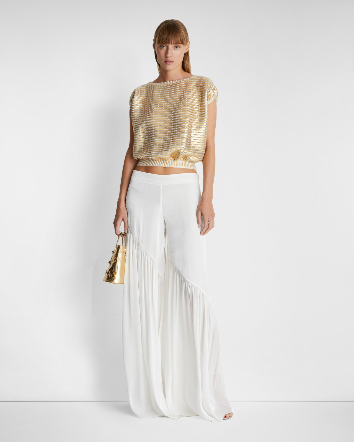 Loose-fitting pants with an asymmetrical design | | Genny
