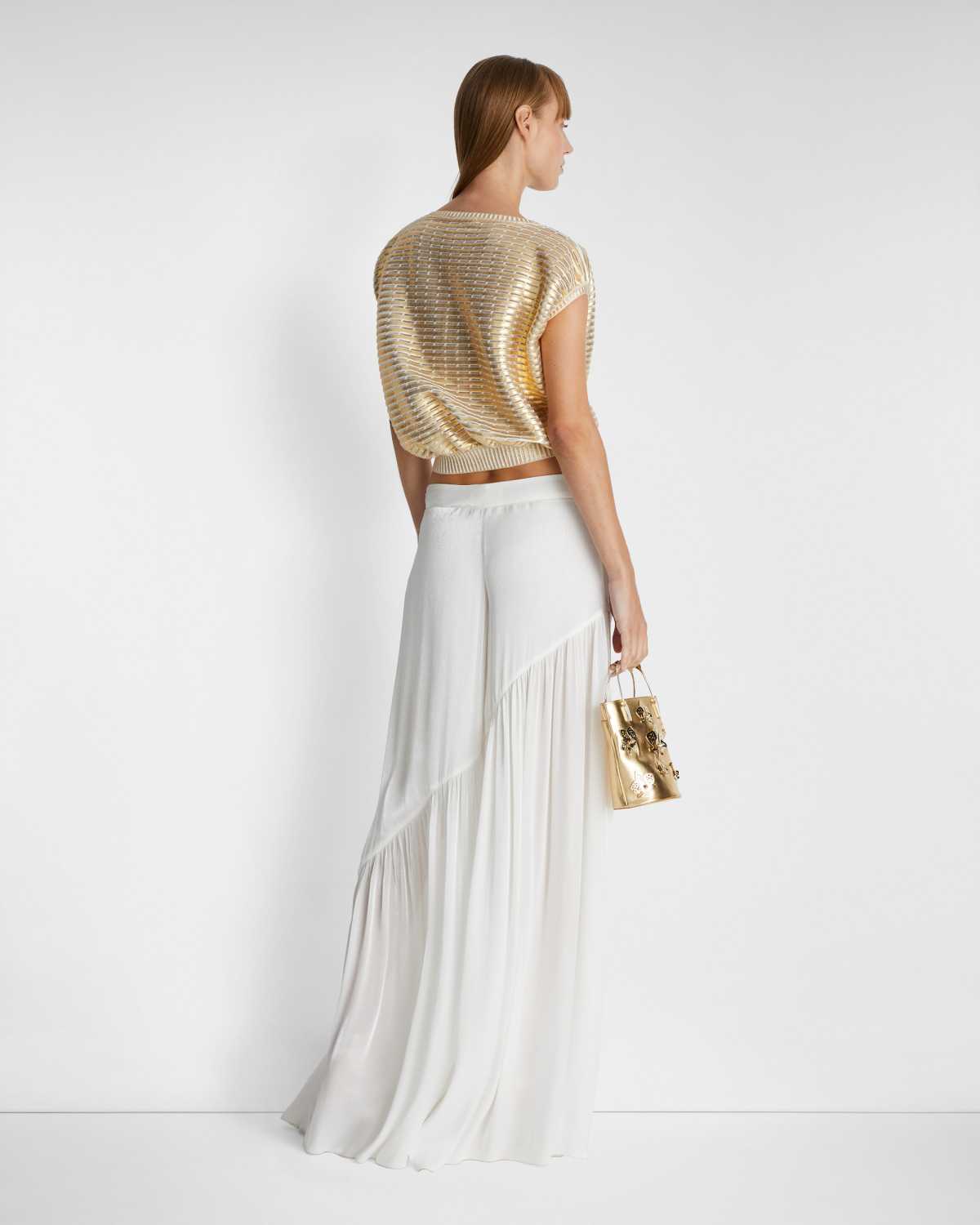 Loose-fitting pants with an asymmetrical design | | Genny