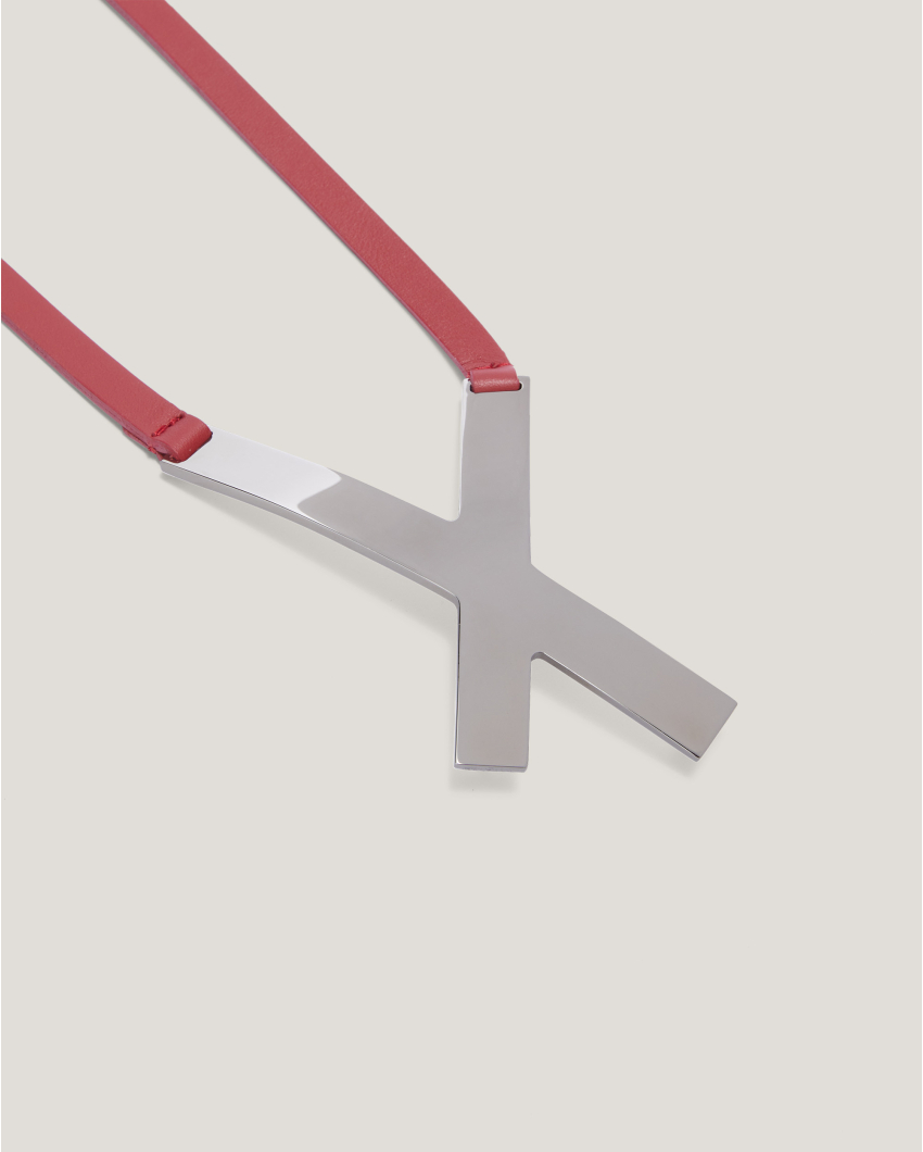 Asymmetrical belt with X buckle